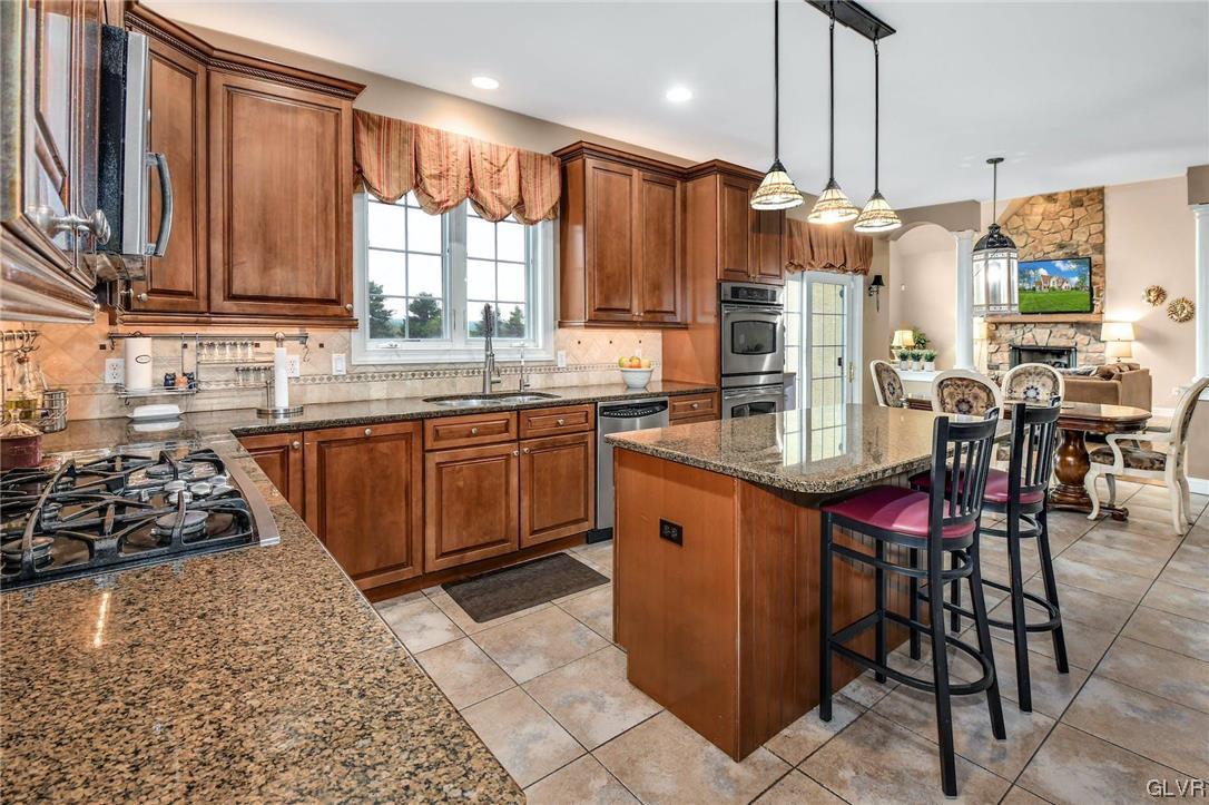 1560 Jakes Place Hellertown, PA 18055 - Photo 10 of 38 a kitchen with stainless steel appliances a sink stove and cabinets