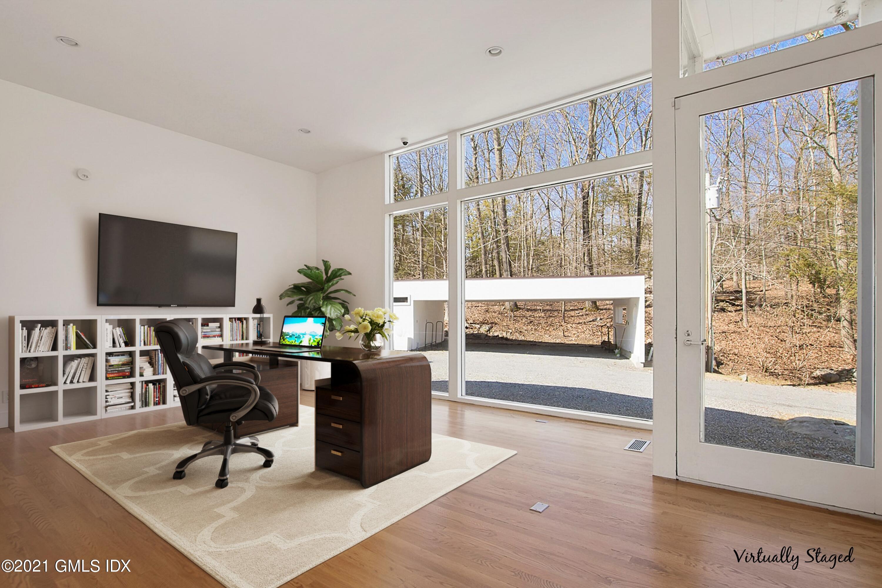 15 Hycliff Road Greenwich, CT 06831 - Photo 11 of 27 a living room with furniture wooden floor and a flat screen tv