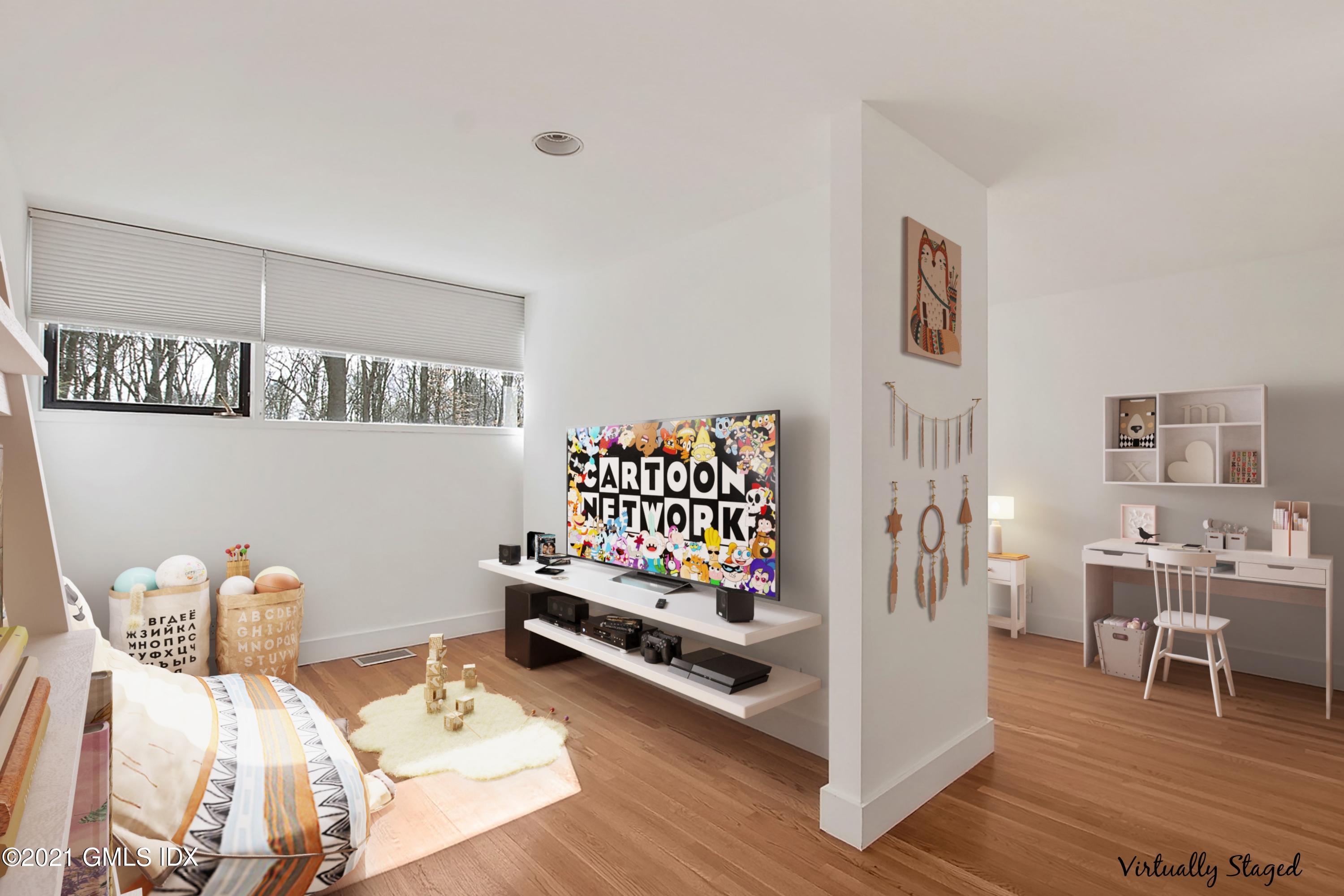 15 Hycliff Road Greenwich, CT 06831 - Photo 15 of 27 a bedroom with furniture and a wooden floor