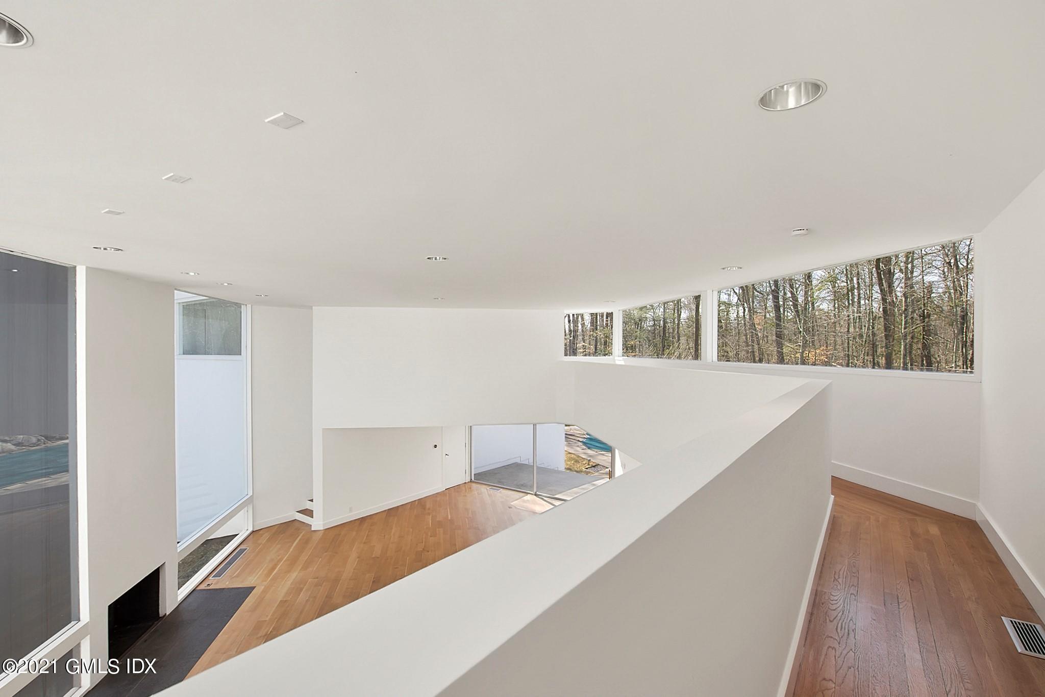 15 Hycliff Road Greenwich, CT 06831 - Photo 17 of 27 a bedroom with a bed and a large window