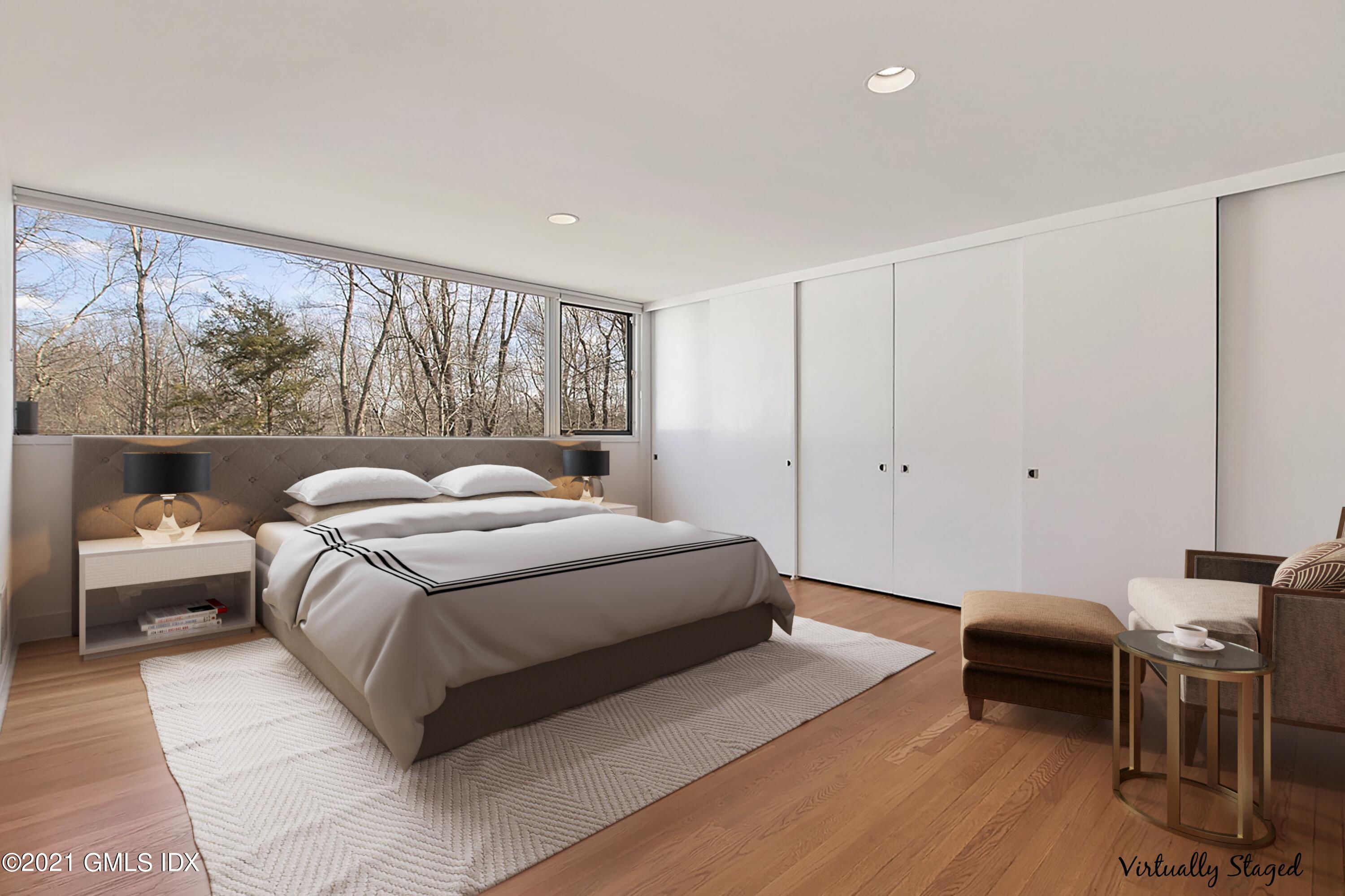 15 Hycliff Road Greenwich, CT 06831 - Photo 19 of 27 a spacious bedroom with a bed and a large window
