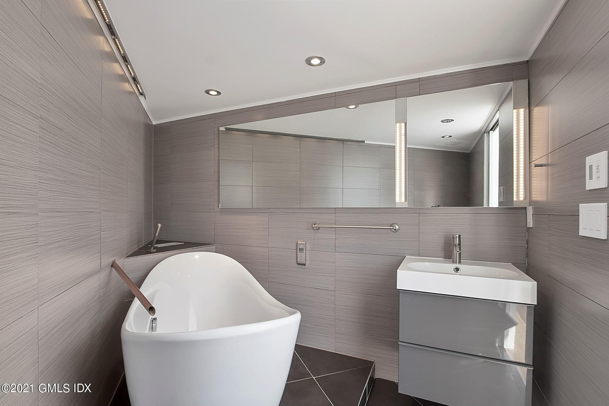 15 Hycliff Road Greenwich, CT 06831 - Photo 20 of 27 a white bath tub sitting in a bathroom