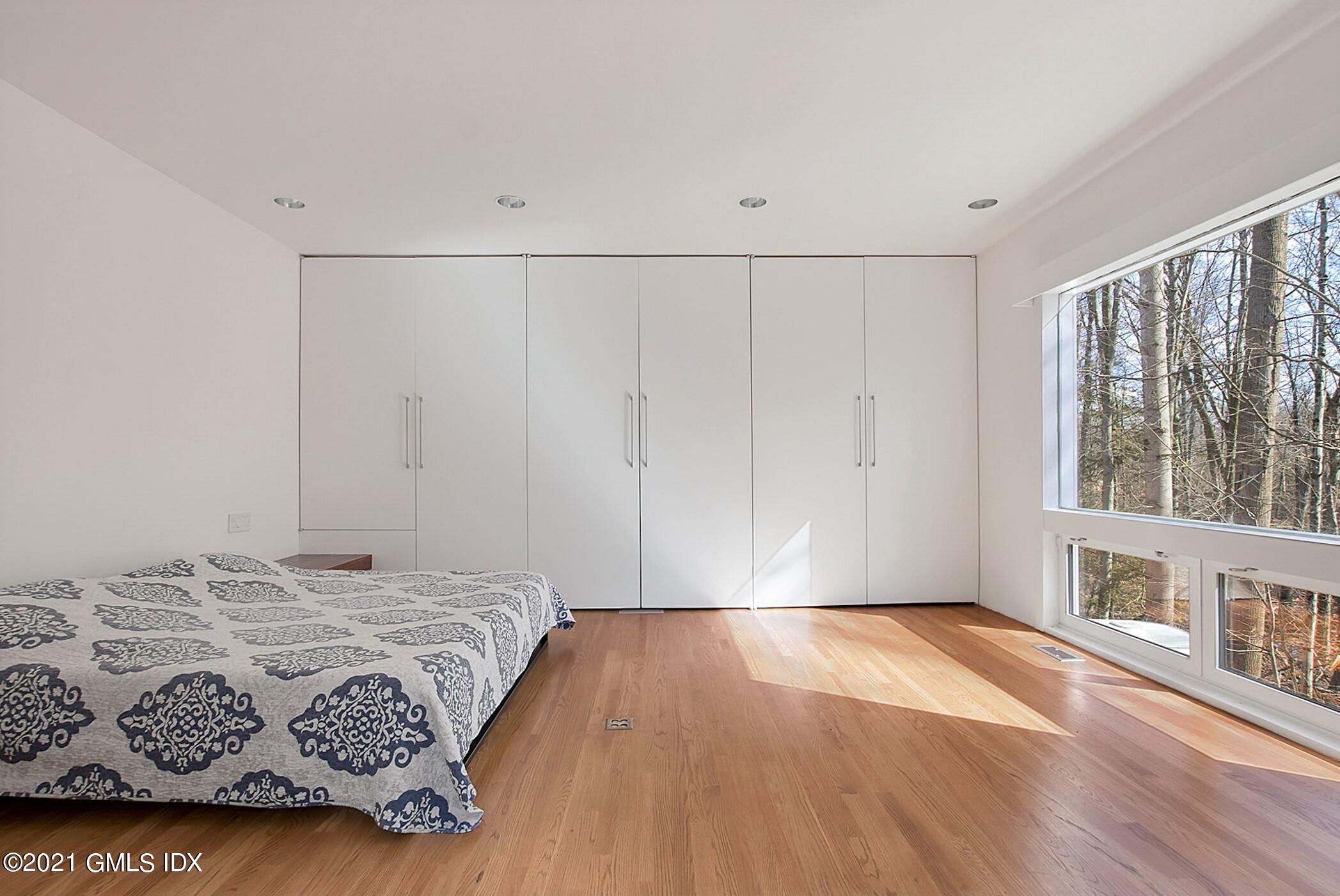 15 Hycliff Road Greenwich, CT 06831 - Photo 21 of 27 a bedroom with a bed and a window