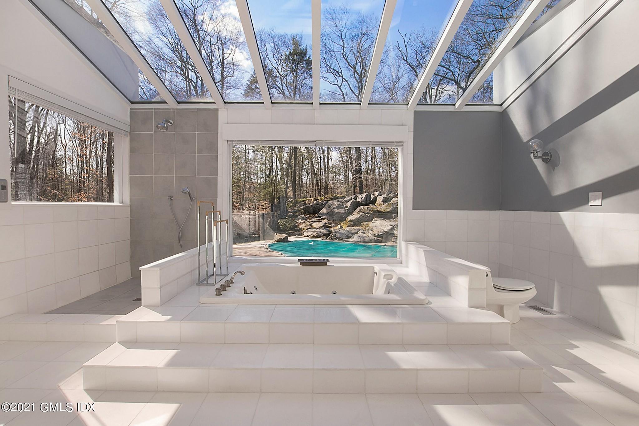 15 Hycliff Road Greenwich, CT 06831 - Photo 23 of 27 a bathroom with a bathtub and window
