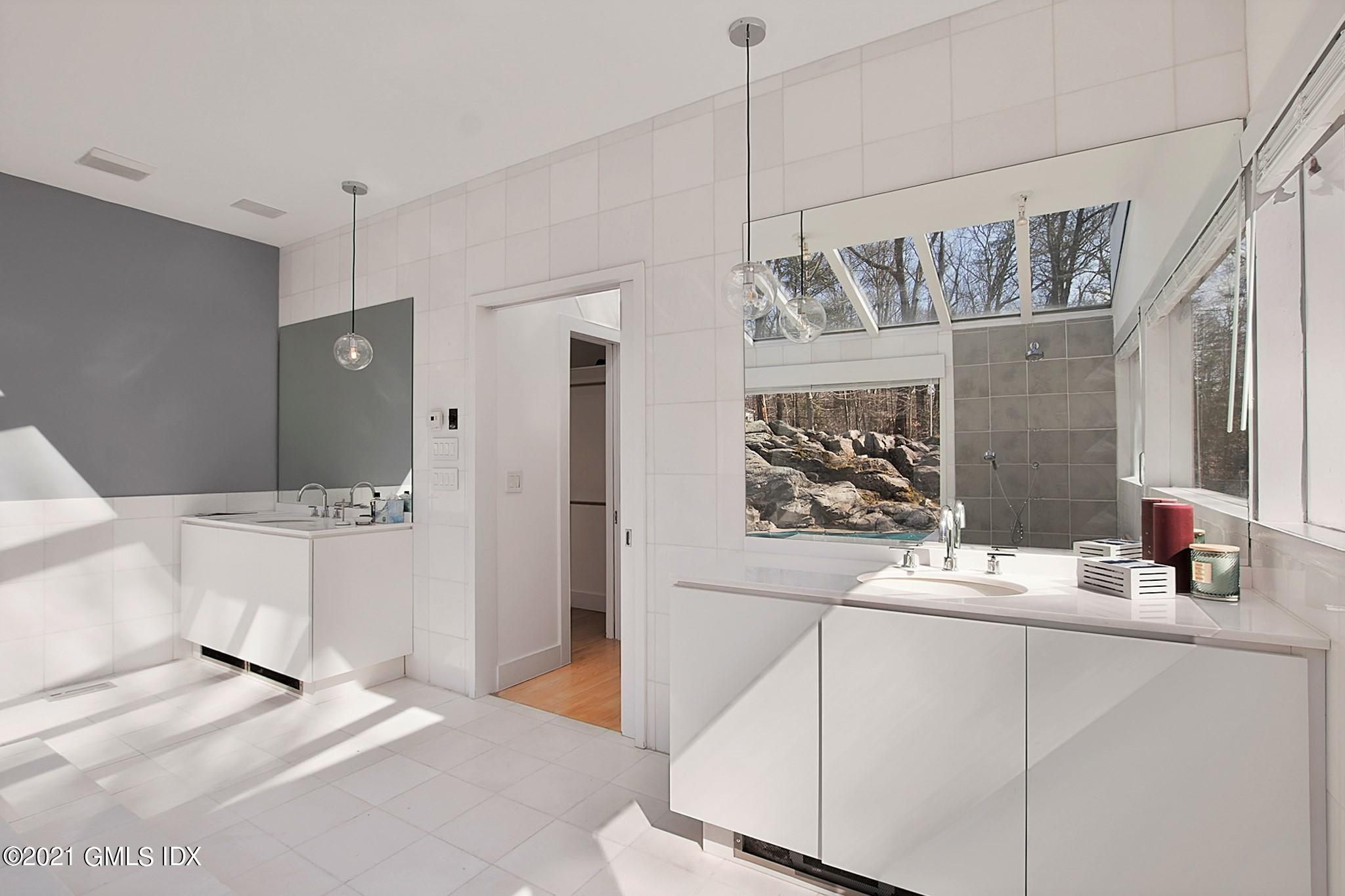 15 Hycliff Road Greenwich, CT 06831 - Photo 24 of 27 a bathroom with a sink and a mirror