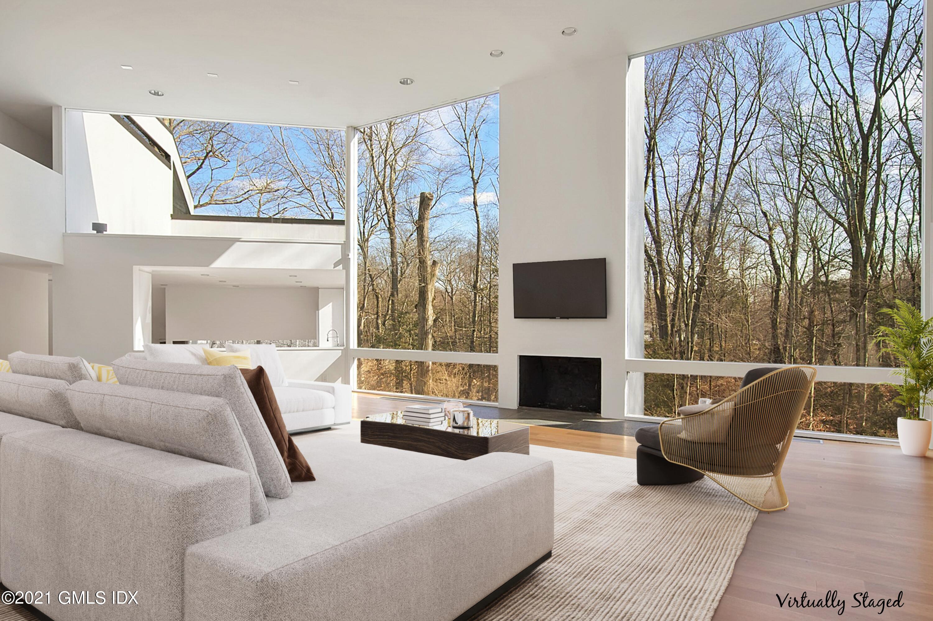 15 Hycliff Road Greenwich, CT 06831 - Photo 4 of 27 a living room with furniture a fireplace and a large window