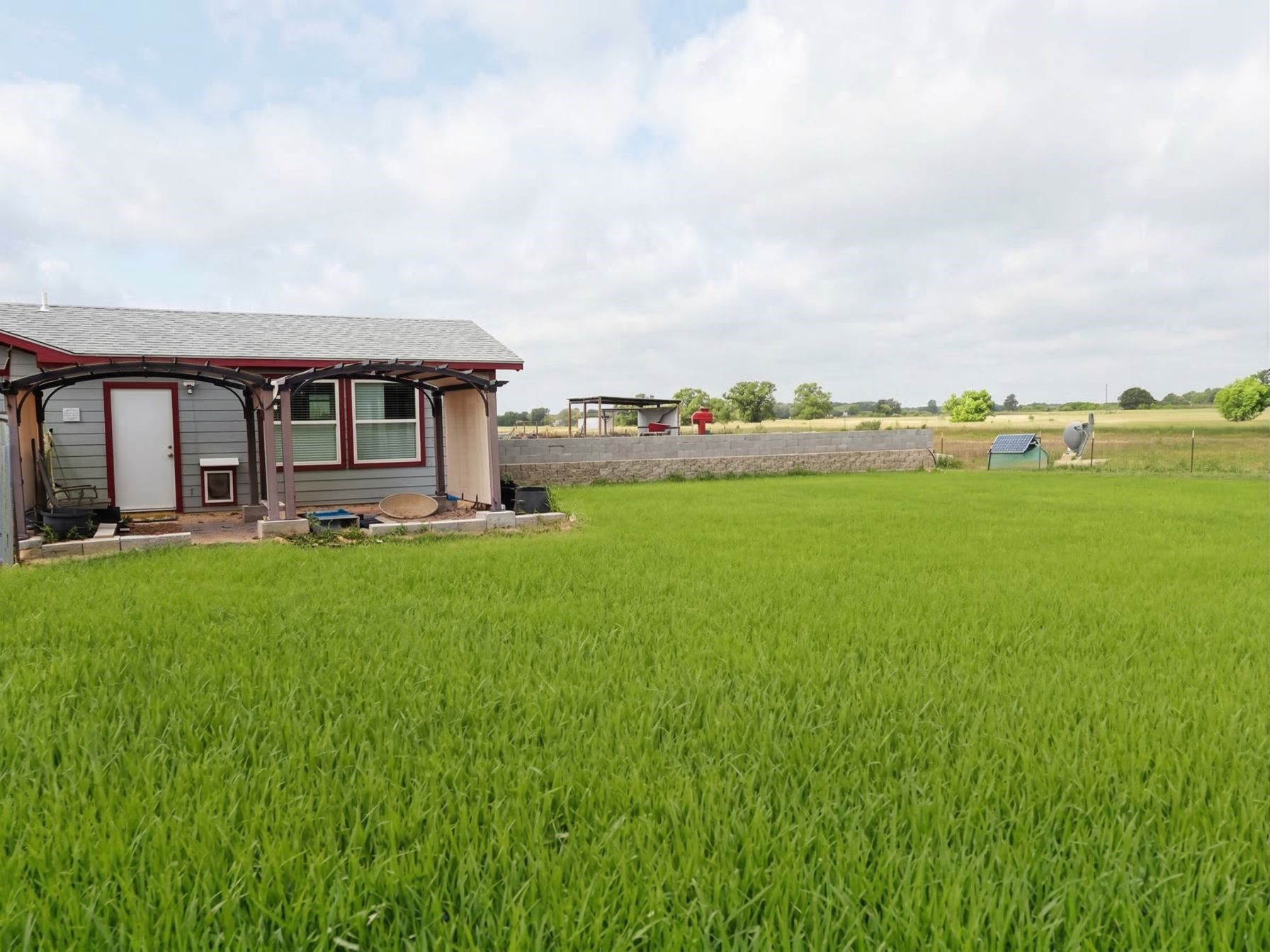 142 Zimmerhanzel Road Flatonia, TX 78941 - Photo 5 of 19 a view of a house with a big yard potted plants and large tree