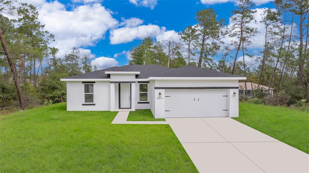 16463 Southwest 54th Ct Road Ocala, FL 34473 - Photo 1 of 1 a front view of a house with a yard and garage