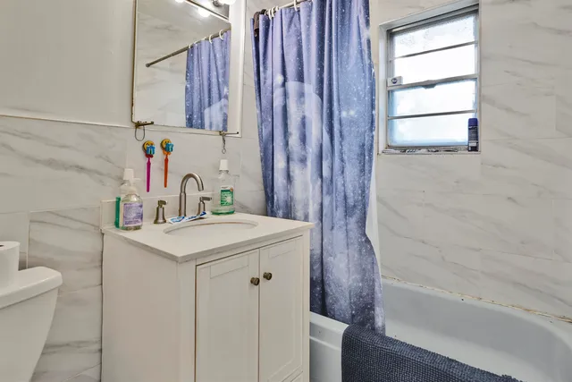 a bathroom with a sink a toilet and a bathtub