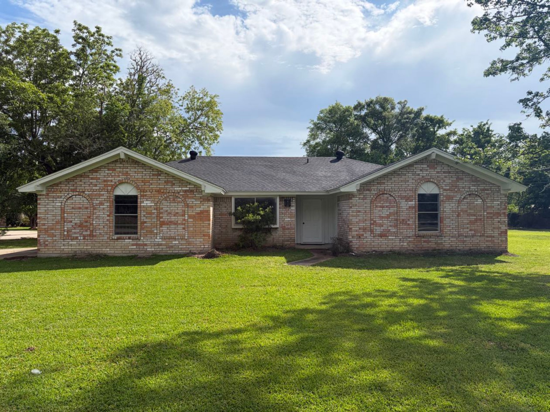 a front view of a house with a yard