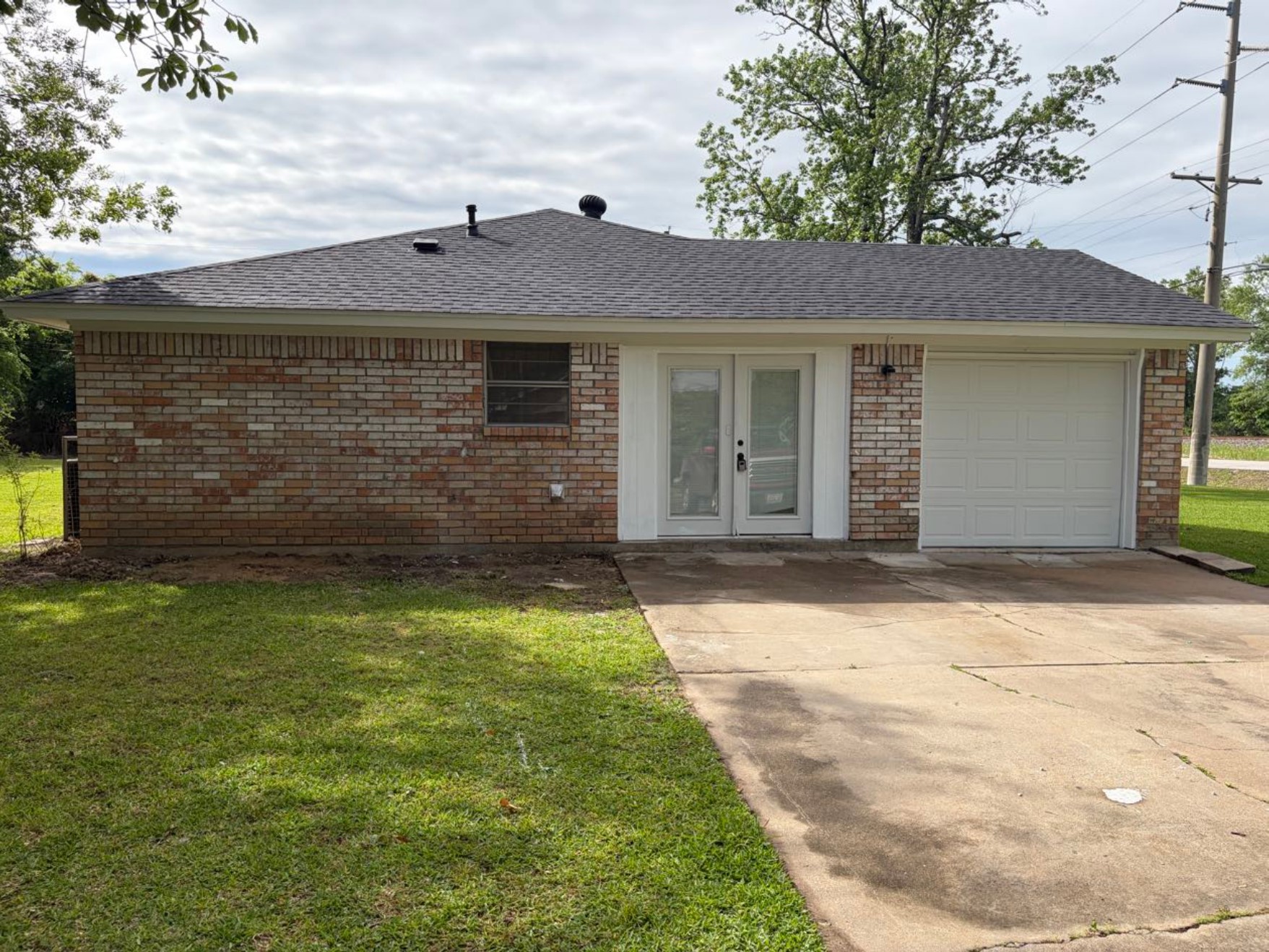 5890 Helbig Road Beaumont, TX 77708 - Photo 2 of 31 a view of a brick house with a yard