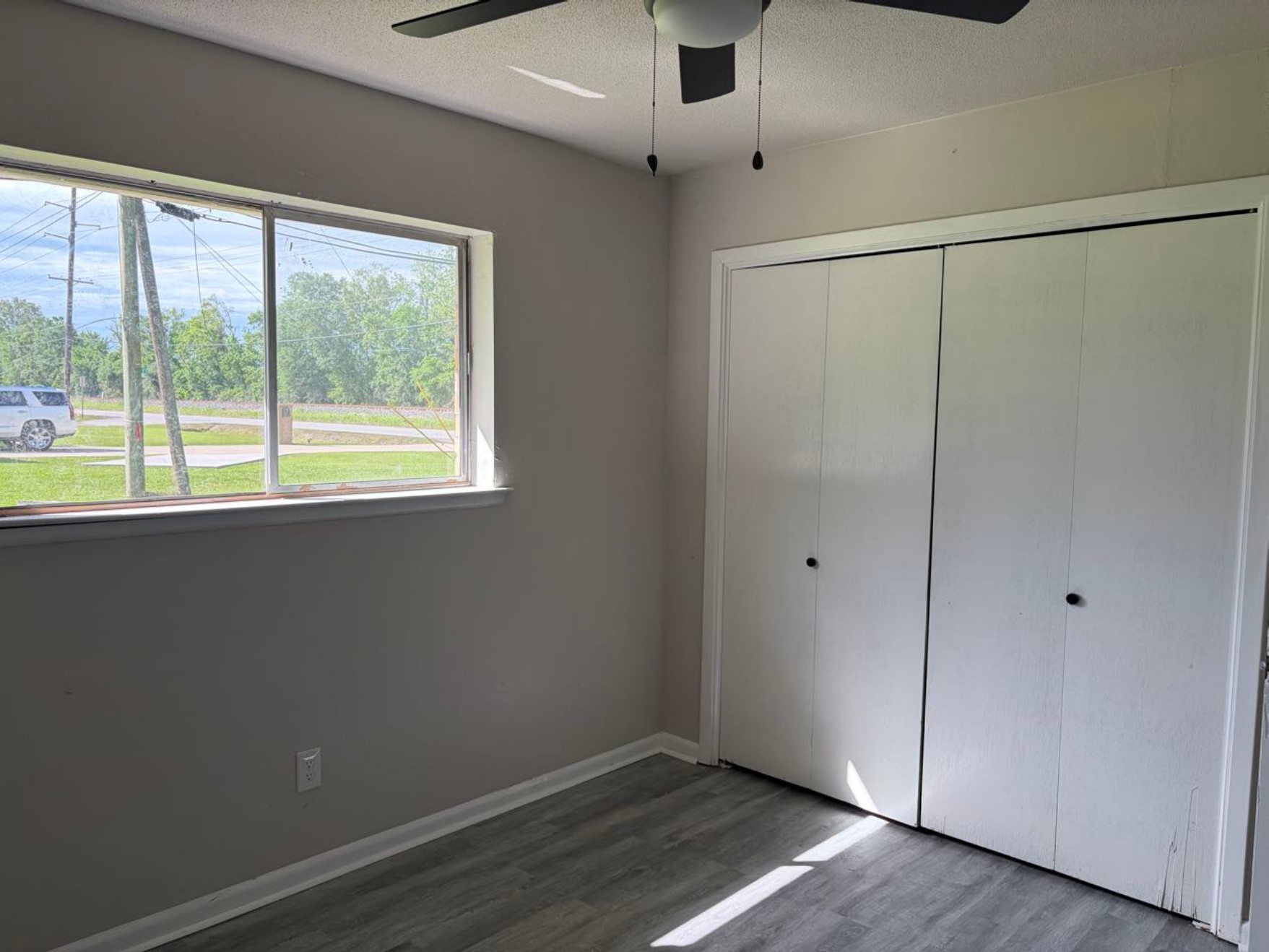 5890 Helbig Road Beaumont, TX 77708 - Photo 23 of 31 a view of an empty room with wooden floor and a window