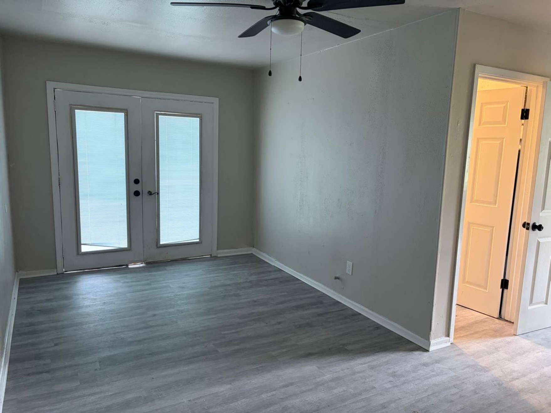 5890 Helbig Road Beaumont, TX 77708 - Photo 3 of 31 an empty room with wooden floor cabinet and windows