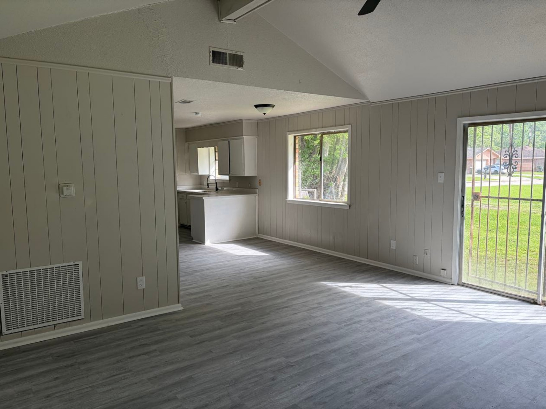 5890 Helbig Road Beaumont, TX 77708 - Photo 5 of 31 a view of an empty room with wooden floor and a window