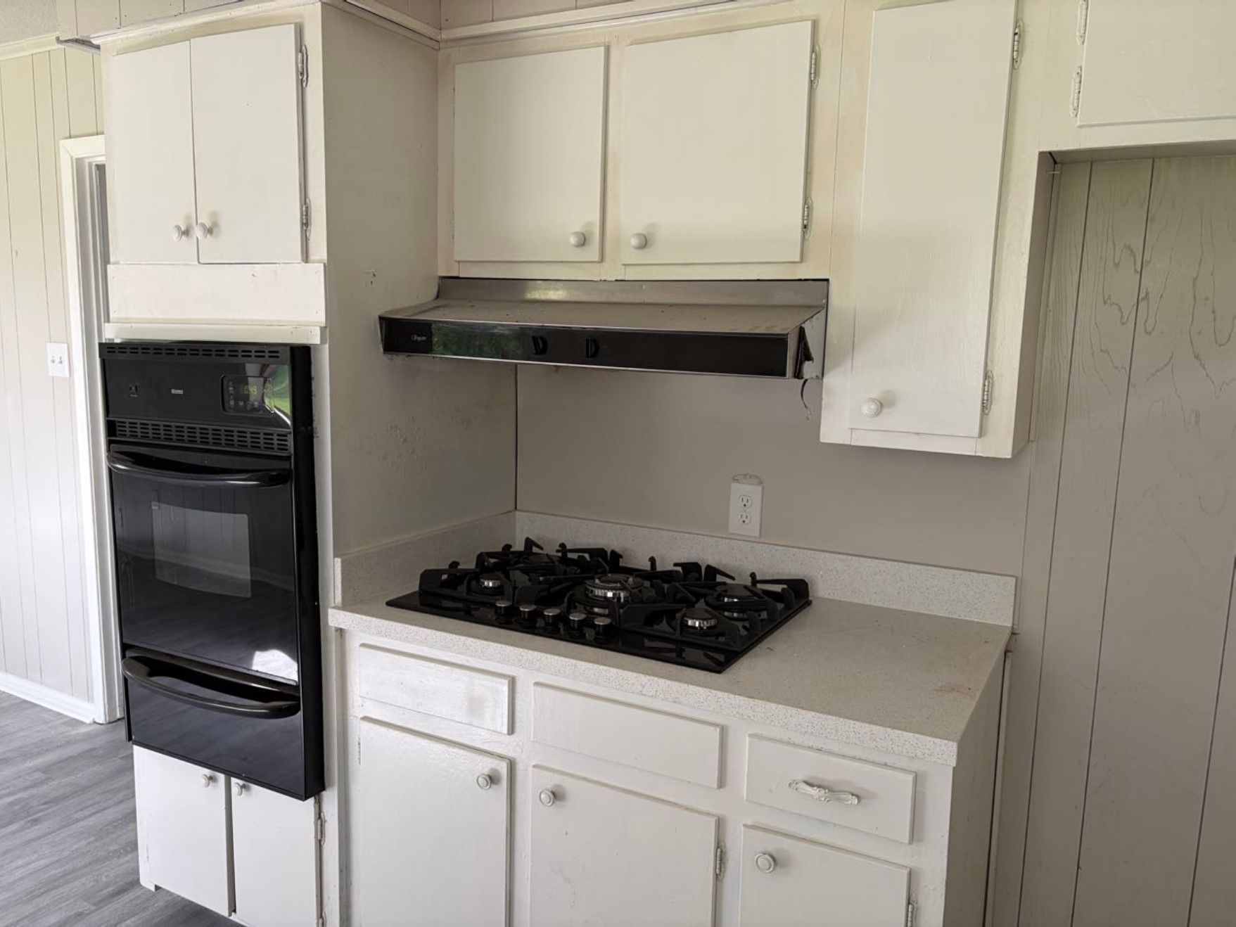 5890 Helbig Road Beaumont, TX 77708 - Photo 8 of 31 a kitchen with white cabinets and black appliances