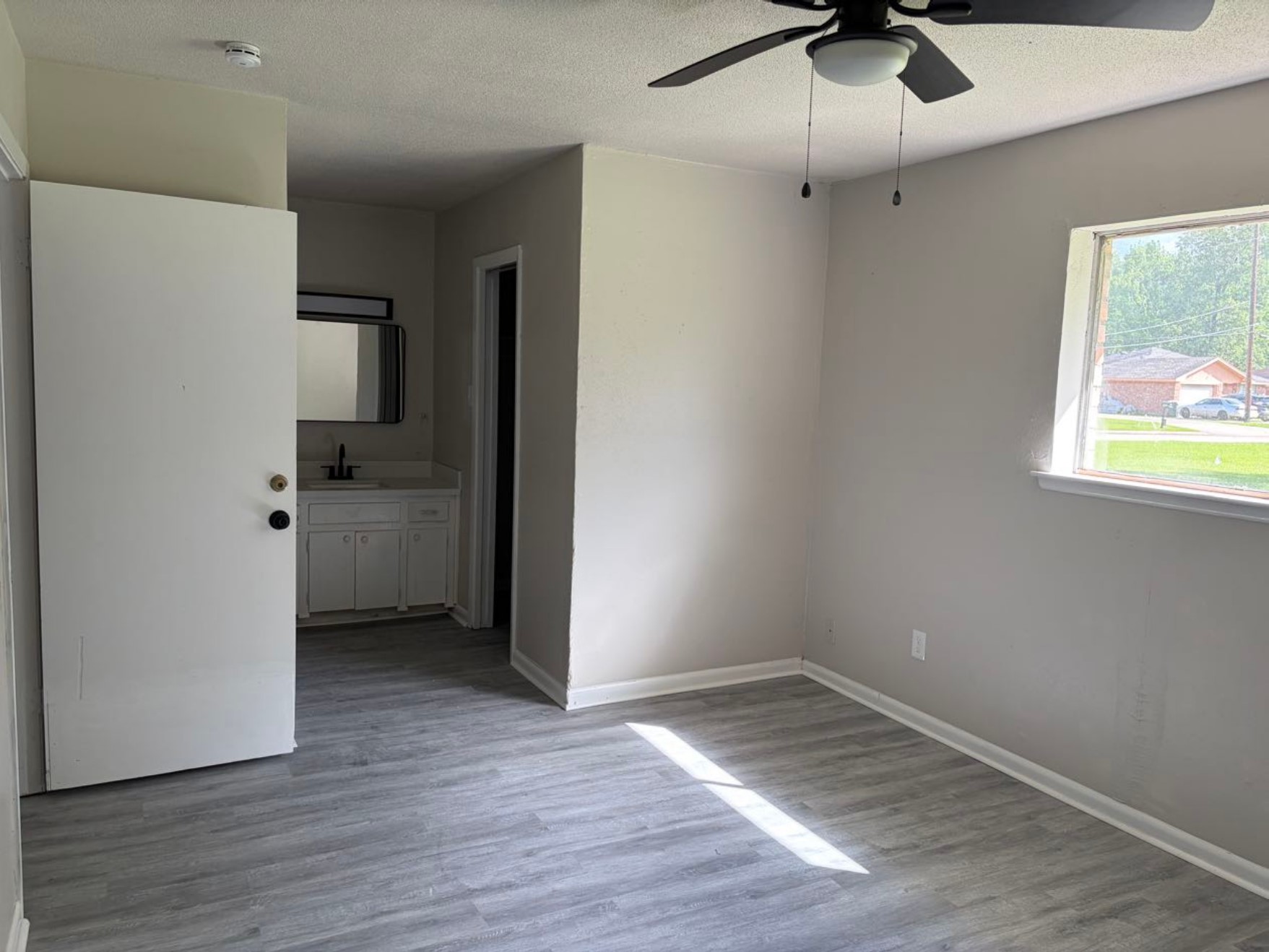 5890 Helbig Road Beaumont, TX 77708 - Photo 9 of 31 an empty room with wooden floor and windows