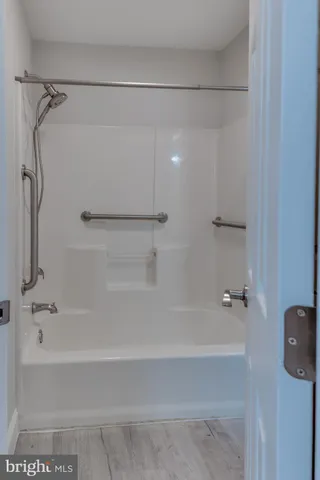 a bathroom with a shower and a bath tub