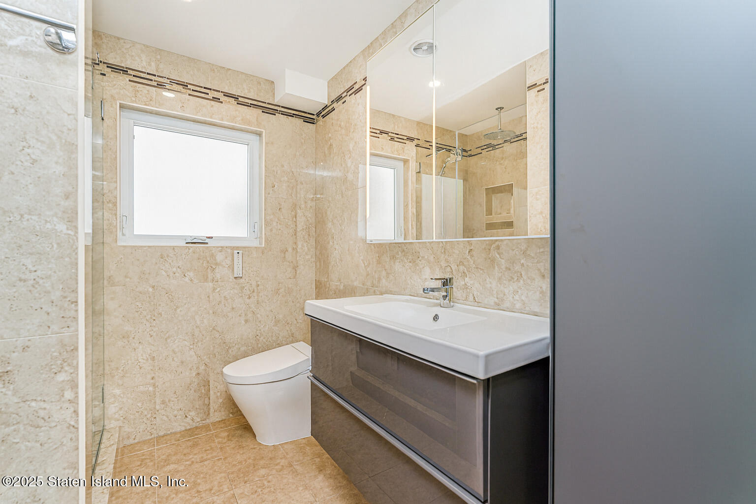 Undisclosed Address Staten Island, NY 10309 - Photo 16 of 40 a bathroom with a sink a toilet a mirror and shower