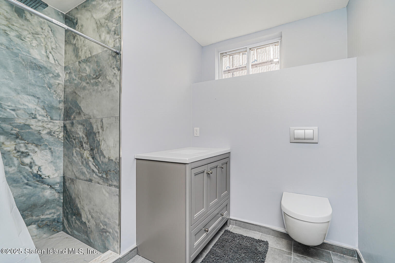 Undisclosed Address Staten Island, NY 10309 - Photo 20 of 40 a bathroom with a granite countertop toilet and a shower