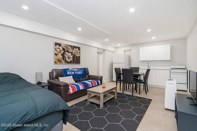 a kitchen with stainless steel appliances granite countertop a stove a sink dishwasher and a microwave with wooden floor