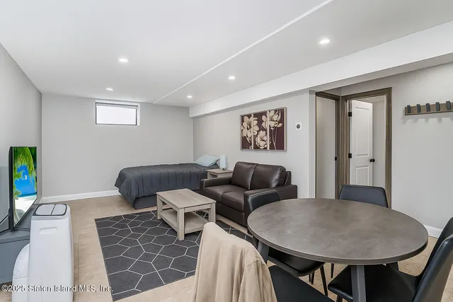 a kitchen with stainless steel appliances granite countertop a table chairs sink refrigerator and cabinets