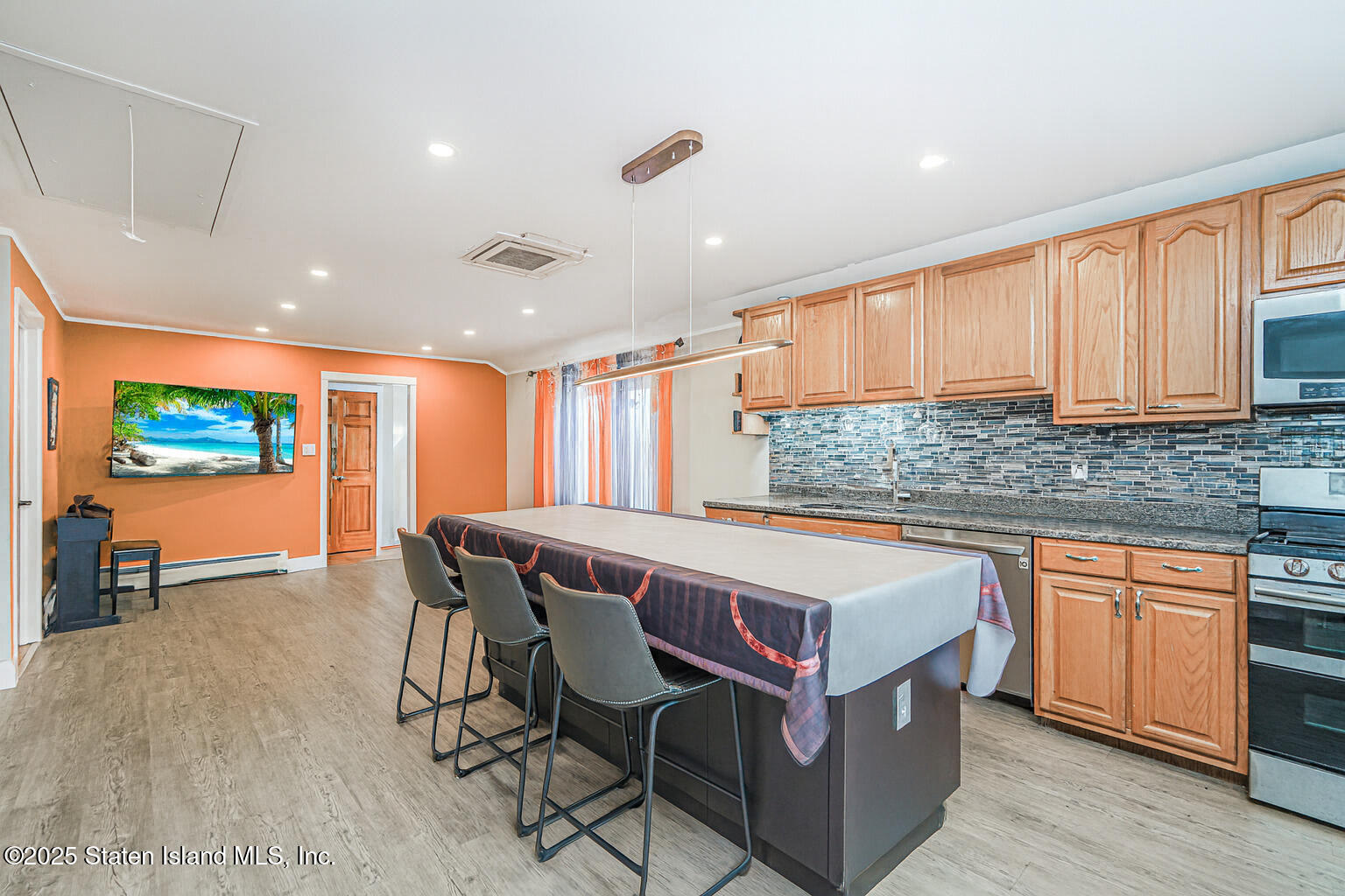 Undisclosed Address Staten Island, NY 10309 - Photo 26 of 40 a kitchen with stainless steel appliances granite countertop a stove a sink dishwasher and a microwave with wooden floor