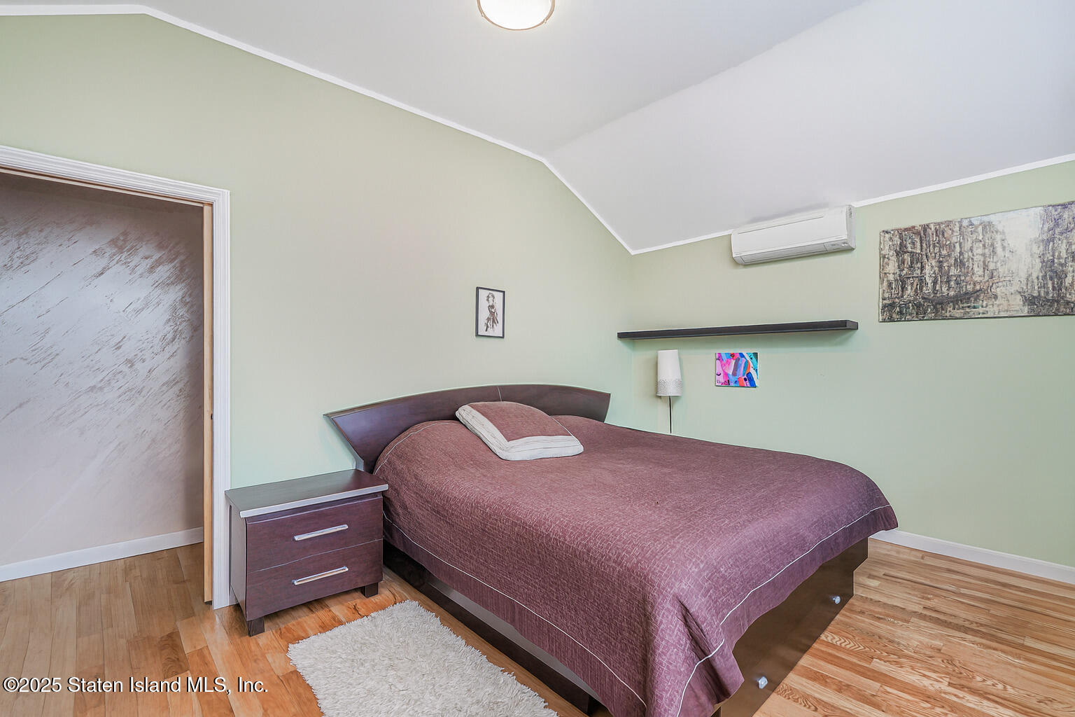 Undisclosed Address Staten Island, NY 10309 - Photo 29 of 40 a bedroom with a bed and wooden floor