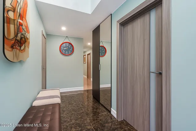 a view of an entryway with hallway and front door