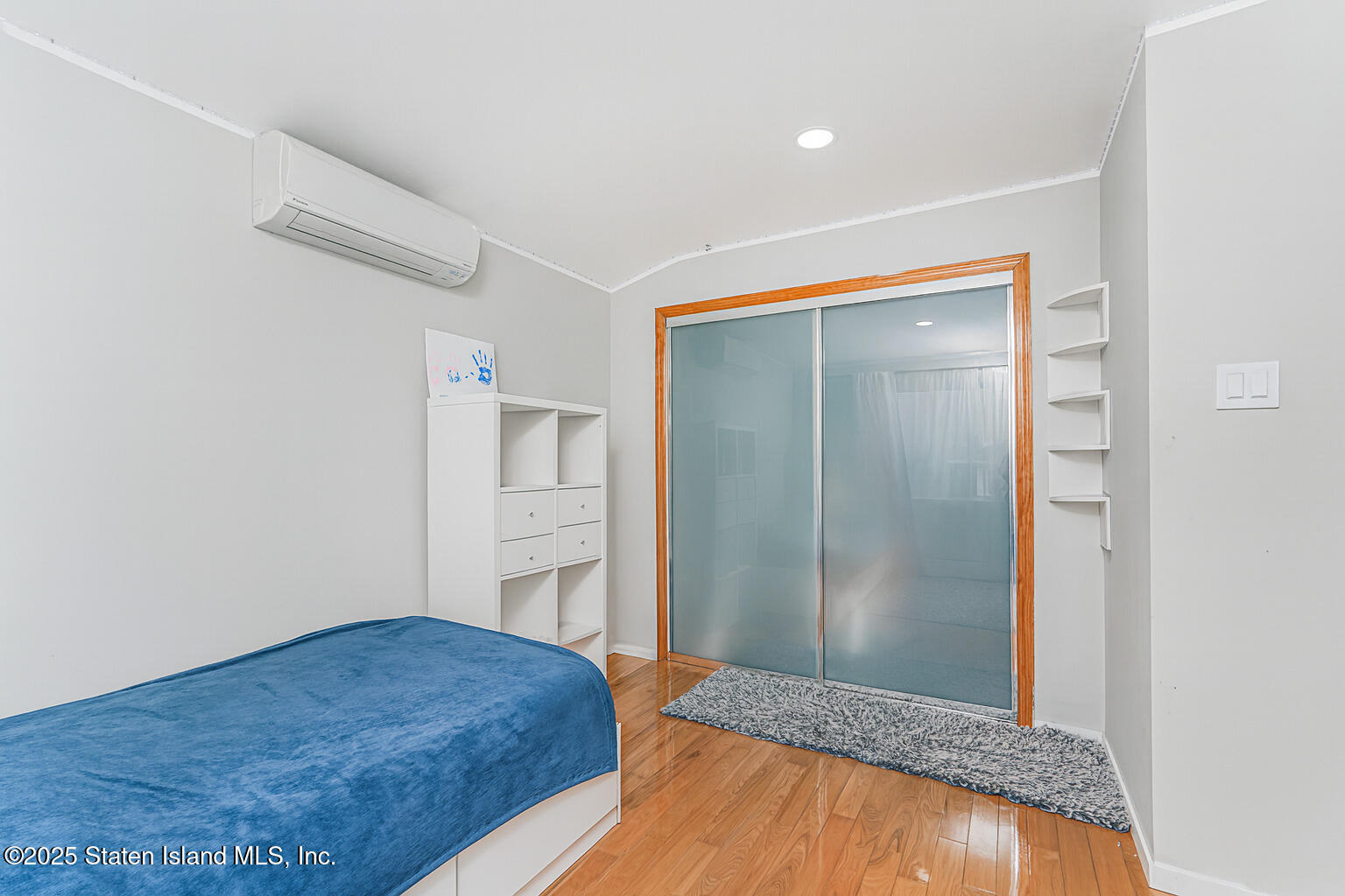 Undisclosed Address Staten Island, NY 10309 - Photo 34 of 40 a bedroom with a bed and wooden floor