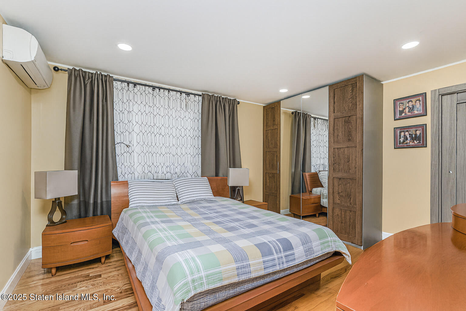 Undisclosed Address Staten Island, NY 10309 - Photo 9 of 40 a bedroom with a large bed and a chandelier