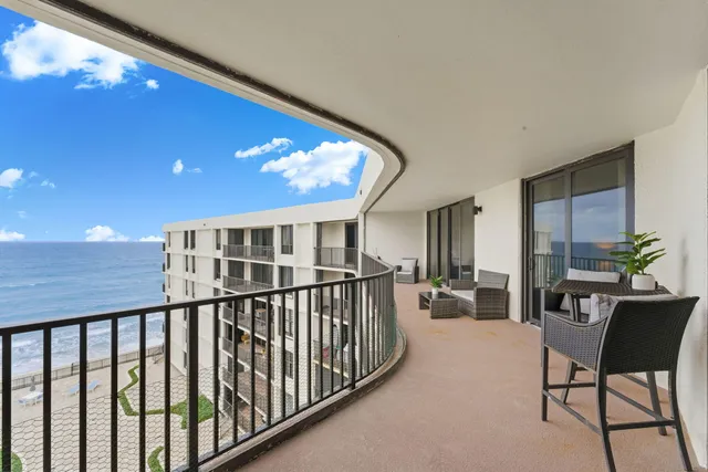 a front view of a multi story residential apartment building with a yard