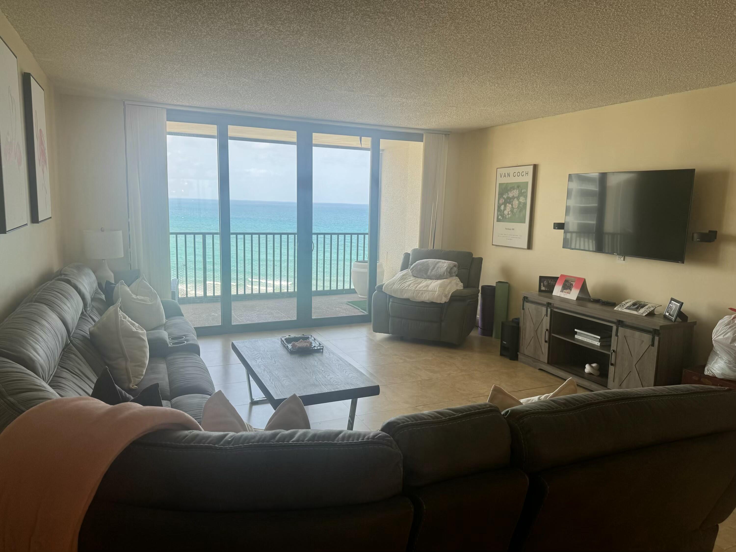 3610 South Ocean Boulevard, Unit 610 South Palm Beach, FL 33480 - Photo 2 of 14 a living room with furniture and a flat screen tv