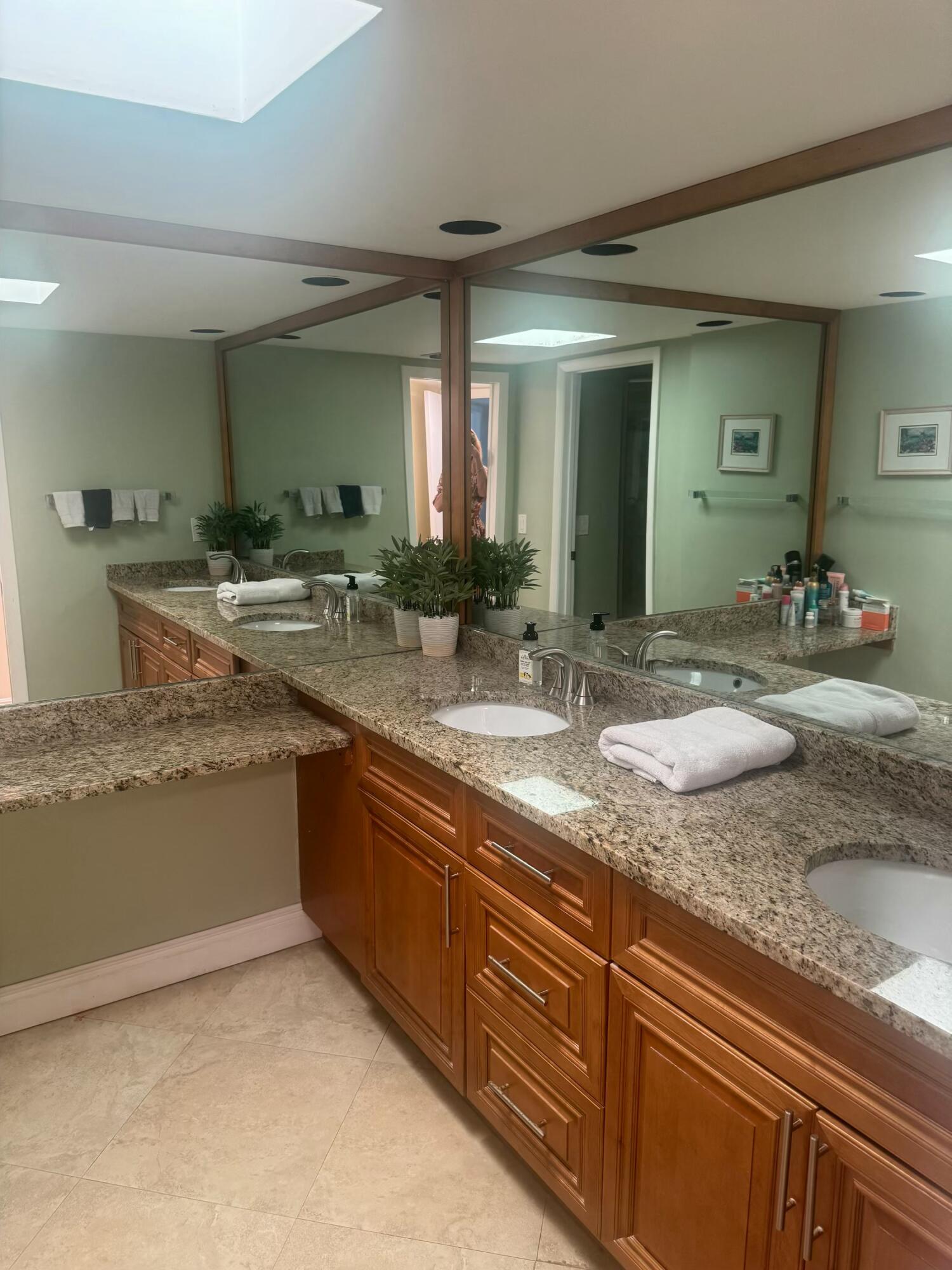 3610 South Ocean Boulevard, Unit 610 South Palm Beach, FL 33480 - Photo 6 of 14 a bathroom with a granite countertop sink and a mirror
