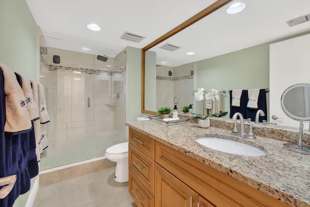 a bathroom with a granite countertop sink mirror and