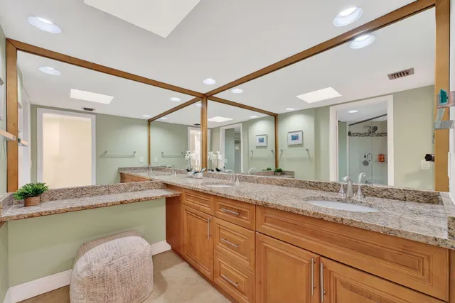 a bedroom with a bed a table and large window