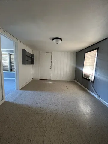 a view of an empty room with glass door