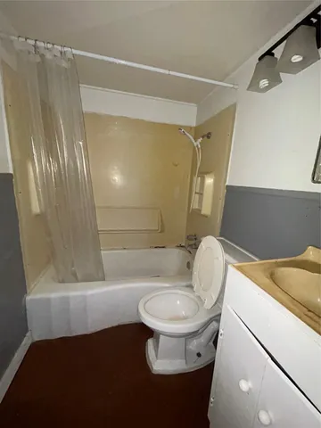 an empty room with a fan and a fan