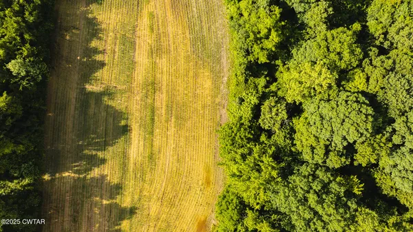 a blue swimming pool is sitting in the middle of a lake