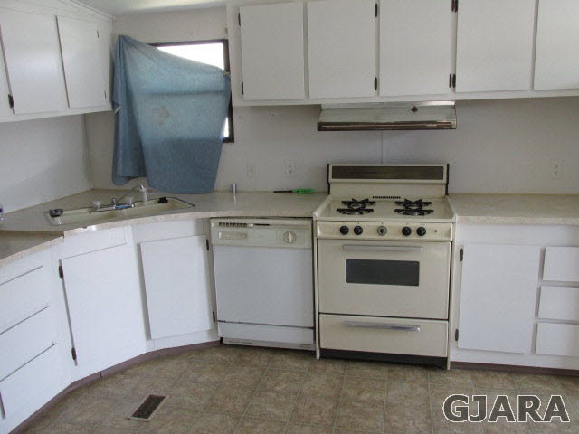 424 32 Road, Unit 151 Clifton, CO 81520 - Photo 5 of 12 a kitchen with granite countertop white cabinets and white appliances