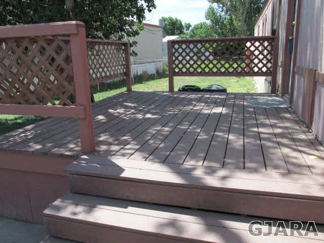 424 32 Road, Unit 151 Clifton, CO 81520 - Photo 8 of 12 a view of a wooden bench next to a yard
