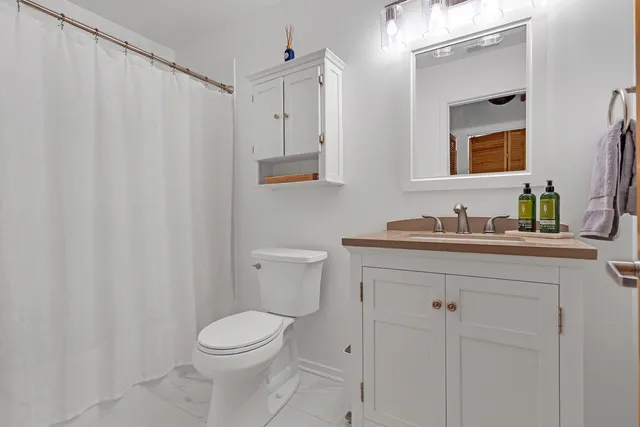 a kitchen with kitchen island granite countertop a sink counter top space and cabinets