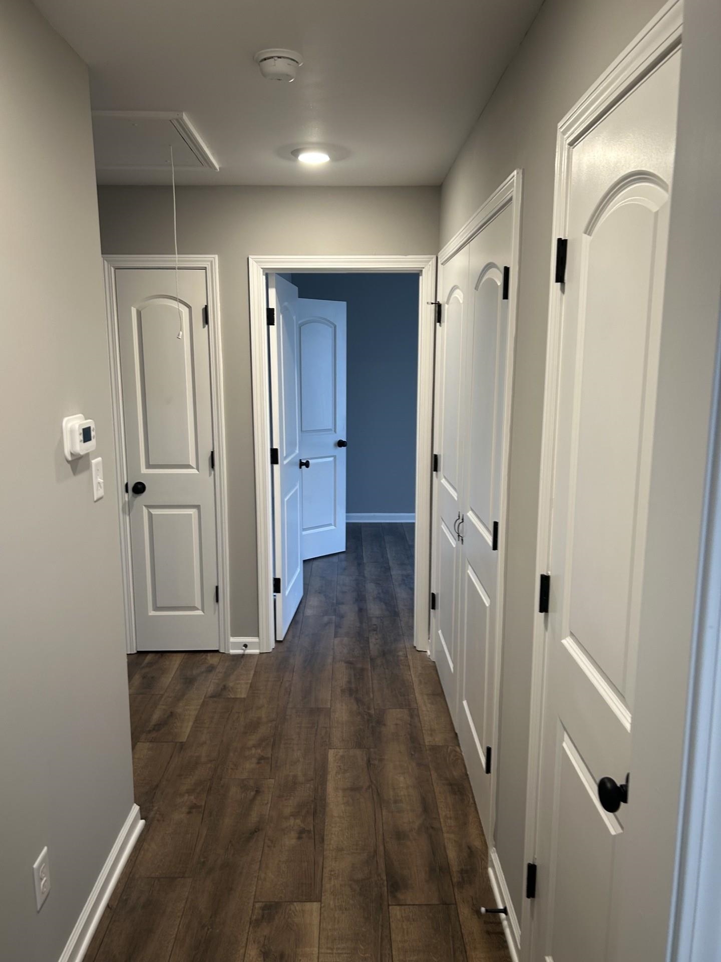 2599 Callie Road Memphis, TN 38127 - Photo 8 of 9 Hallway with wood-finish flooring, white doors with black hardware, recessed lighting, and light gray walls