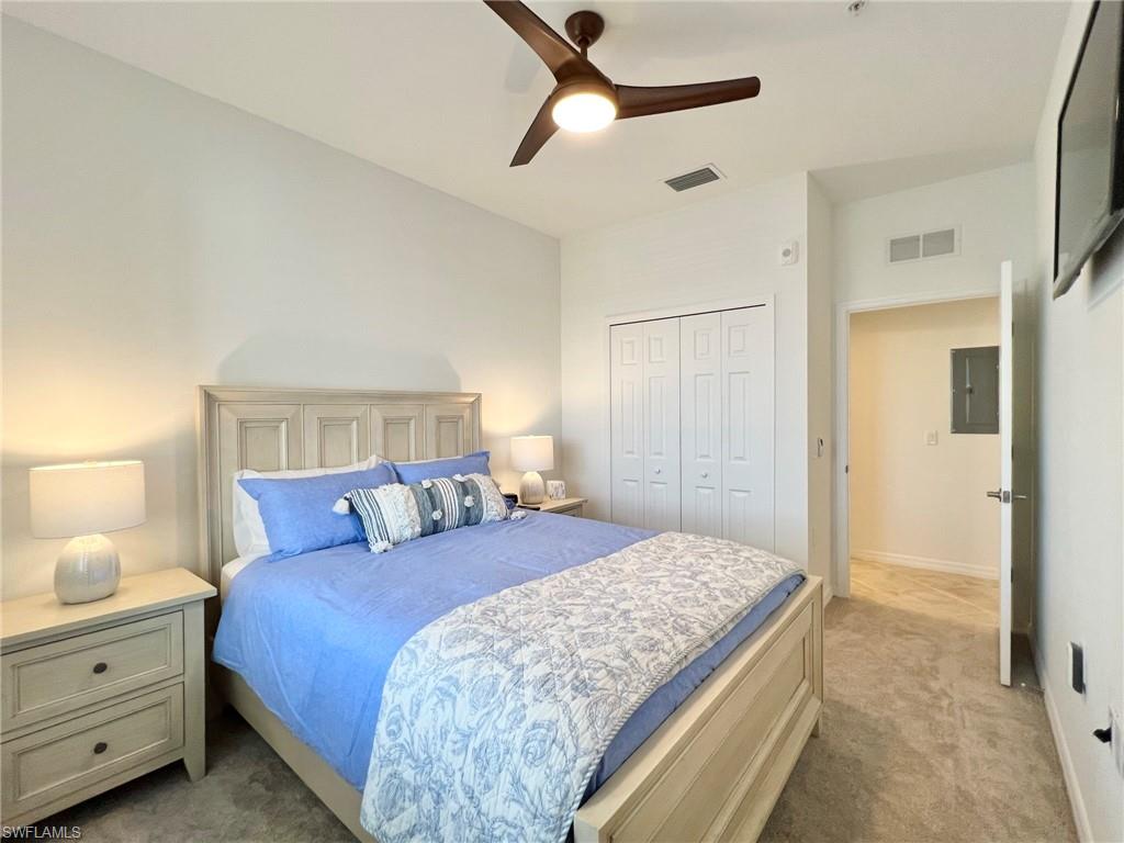 43020 Greenway Boulevard, Unit 345 Babcock Ranch, FL 33982 - Photo 12 of 42 a bedroom with a large bed and a chandelier