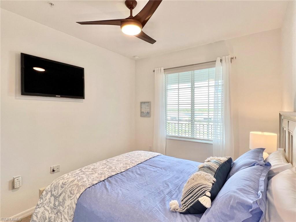 43020 Greenway Boulevard, Unit 345 Babcock Ranch, FL 33982 - Photo 13 of 42 a bedroom with a bed and a flat screen tv
