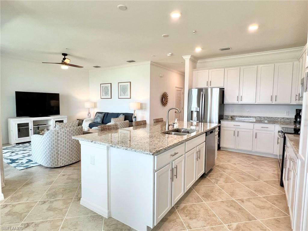 43020 Greenway Boulevard, Unit 345 Babcock Ranch, FL 33982 - Photo 7 of 42 a large kitchen with stainless steel appliances kitchen island granite countertop a sink and cabinets