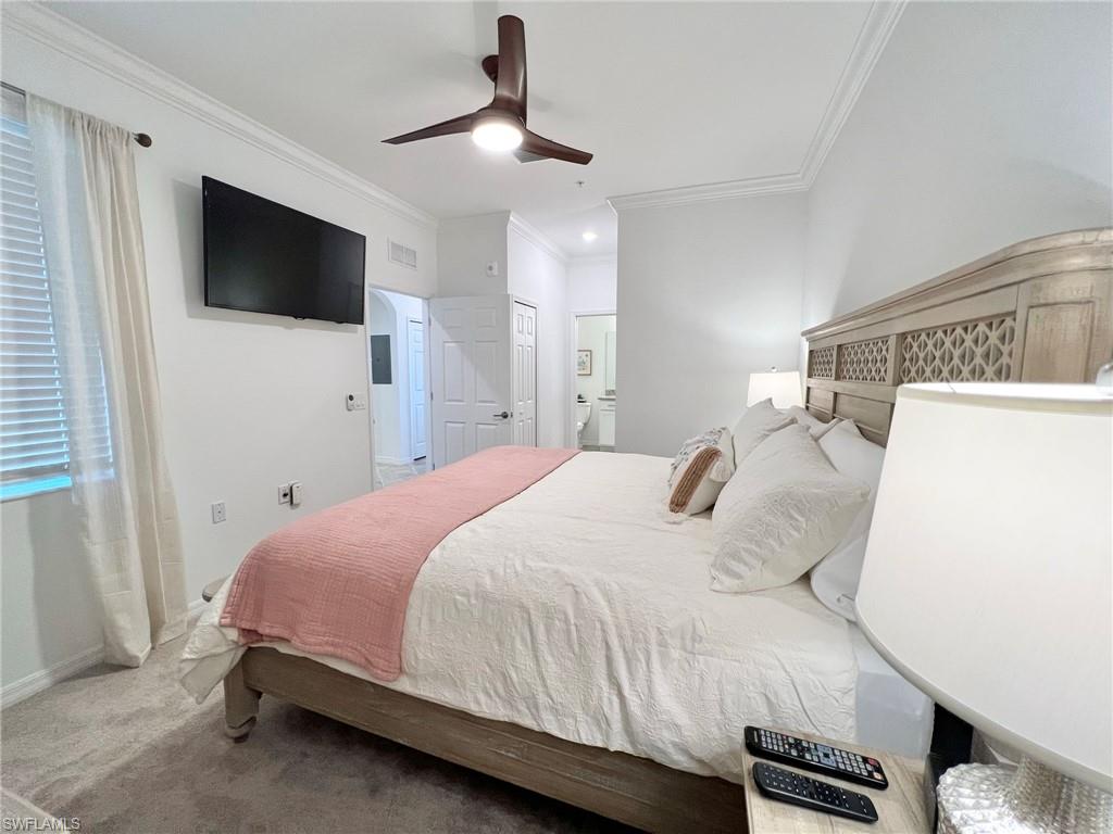 43020 Greenway Boulevard, Unit 345 Babcock Ranch, FL 33982 - Photo 9 of 42 a bedroom with a bed and a flat tv screen