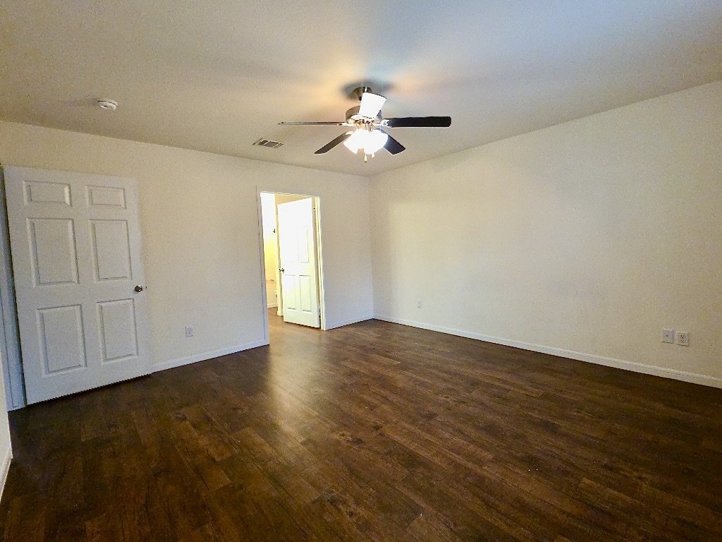 306 Wyeth Street Taylor, TX 76574 - Photo 10 of 20 Bedroom with laminate flooring, ceiling fan and neutral paint.
