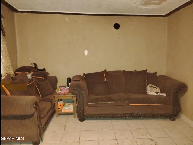 a couch sitting in a room next to a blue wall