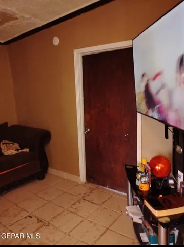 a room with a chair and potted plant