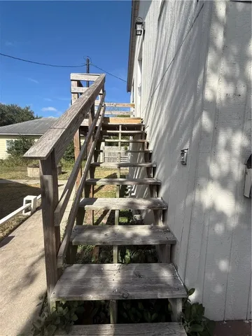a view of a balcony with wooden floor and outdoor seating